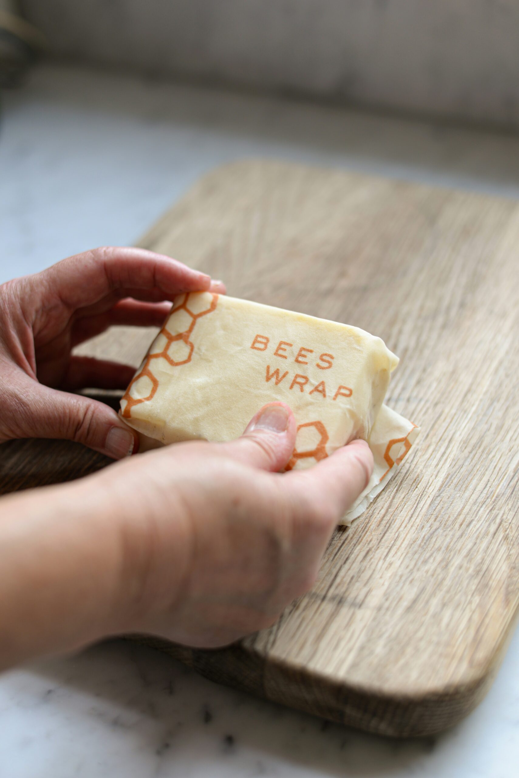 Reusable beeswax wrap being used for food