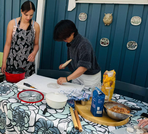 Participants rolling and preparing dumpling dough together